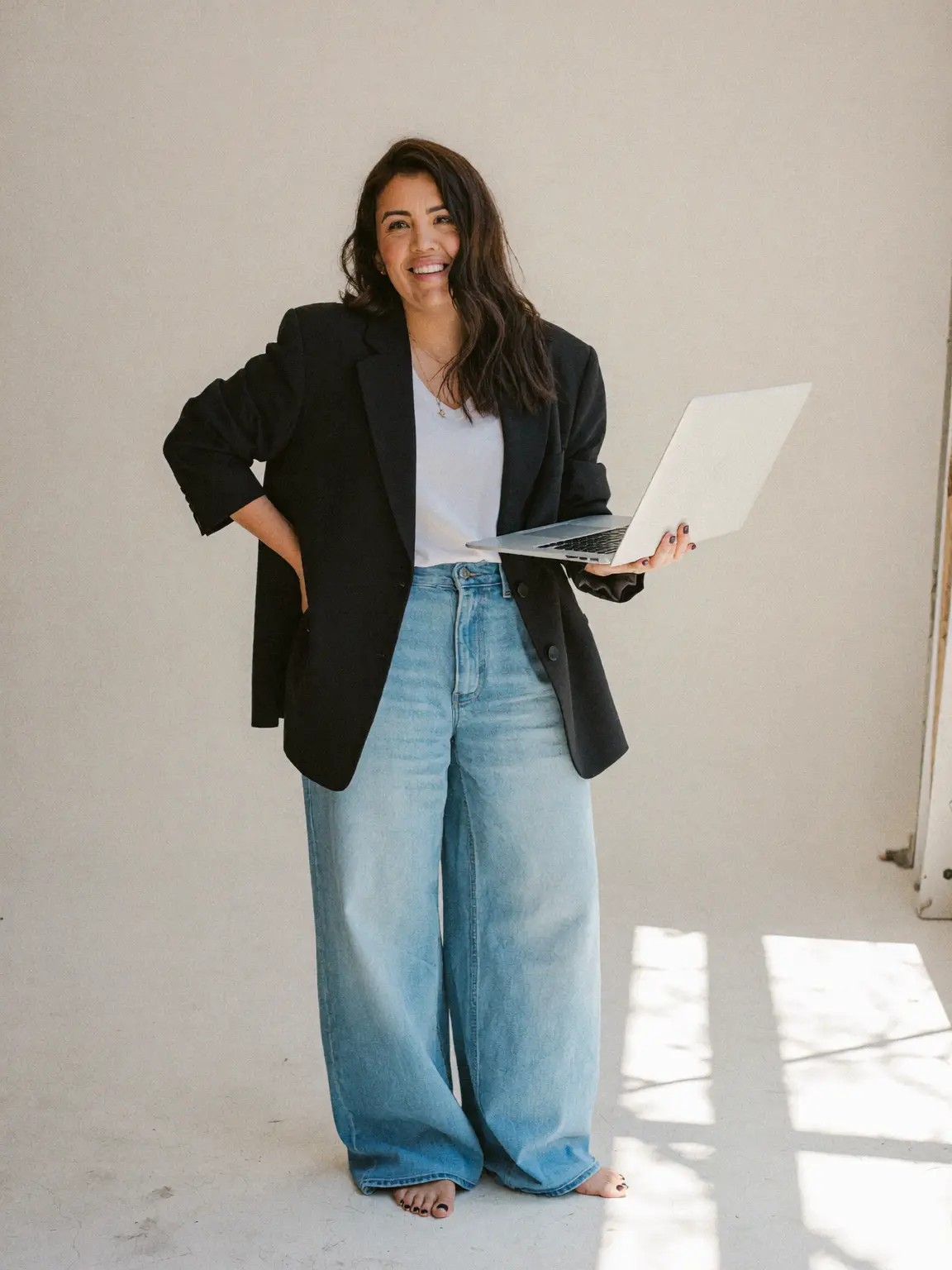 Molly Lannen standing with an open laptop